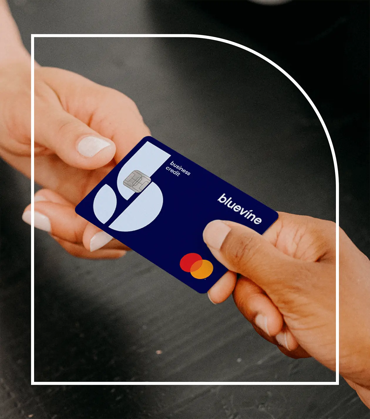 A person handing a Bluevine credit card to another person