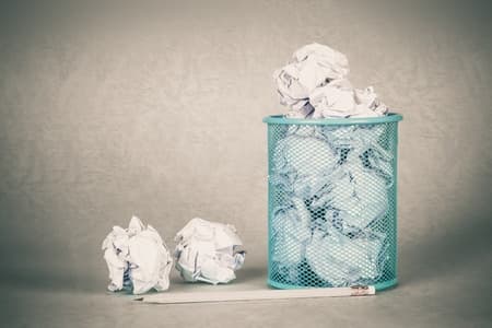 Crumpled paper in a trash can