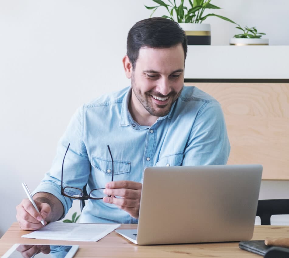 Image of man sitting at computer filling out paperwork for incorporation of business