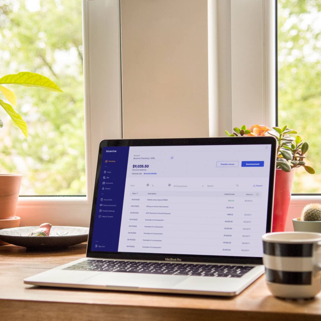 Laptop on the desk with a Bluevine Business Checking account dashboard featuring new Bills Inbox for streamlined accounts payable