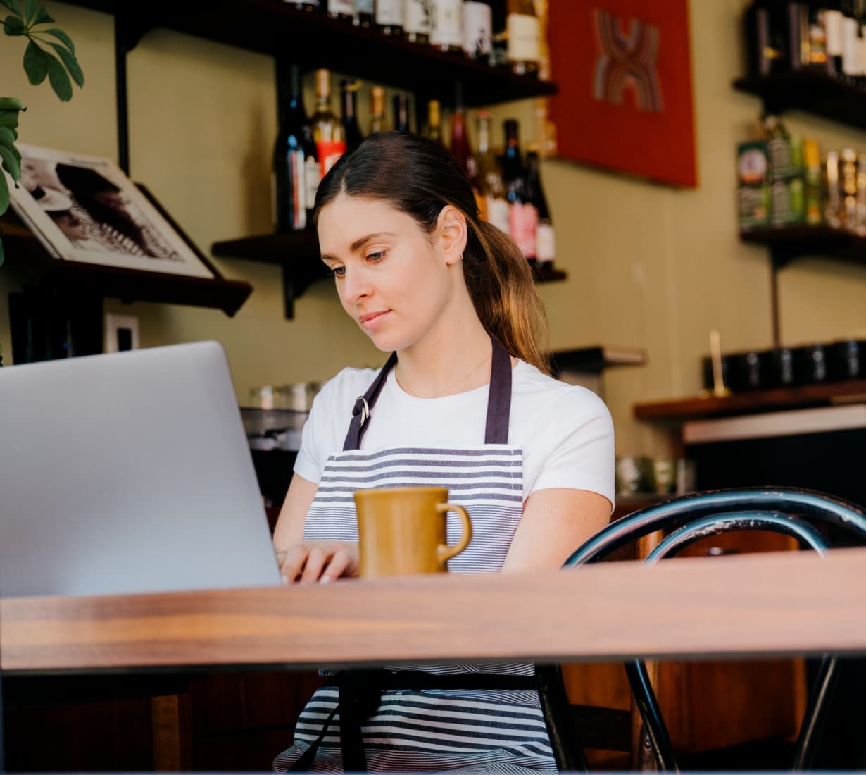 cafe owner on laptop switches business bank blog