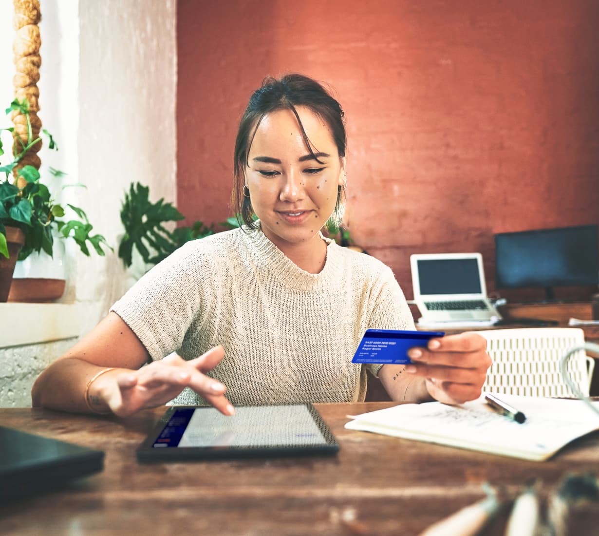 woman pays business expenses by credit card on tablet blog