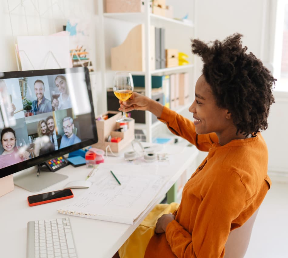 Remote team members enjoy a virtual happy hour for team building.