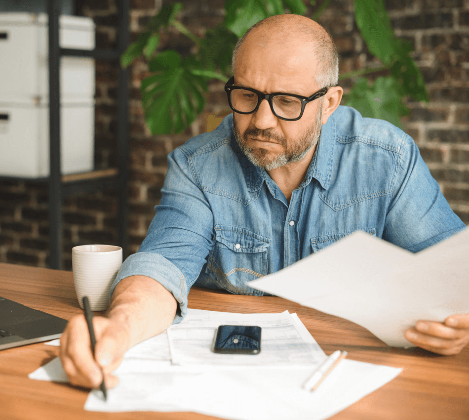Small business owner works on tax returns based on the year's income tax brackets.