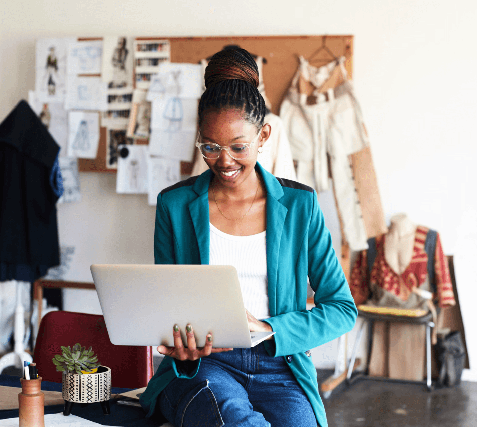 A female business owner applies for a startup business loan from her laptop.