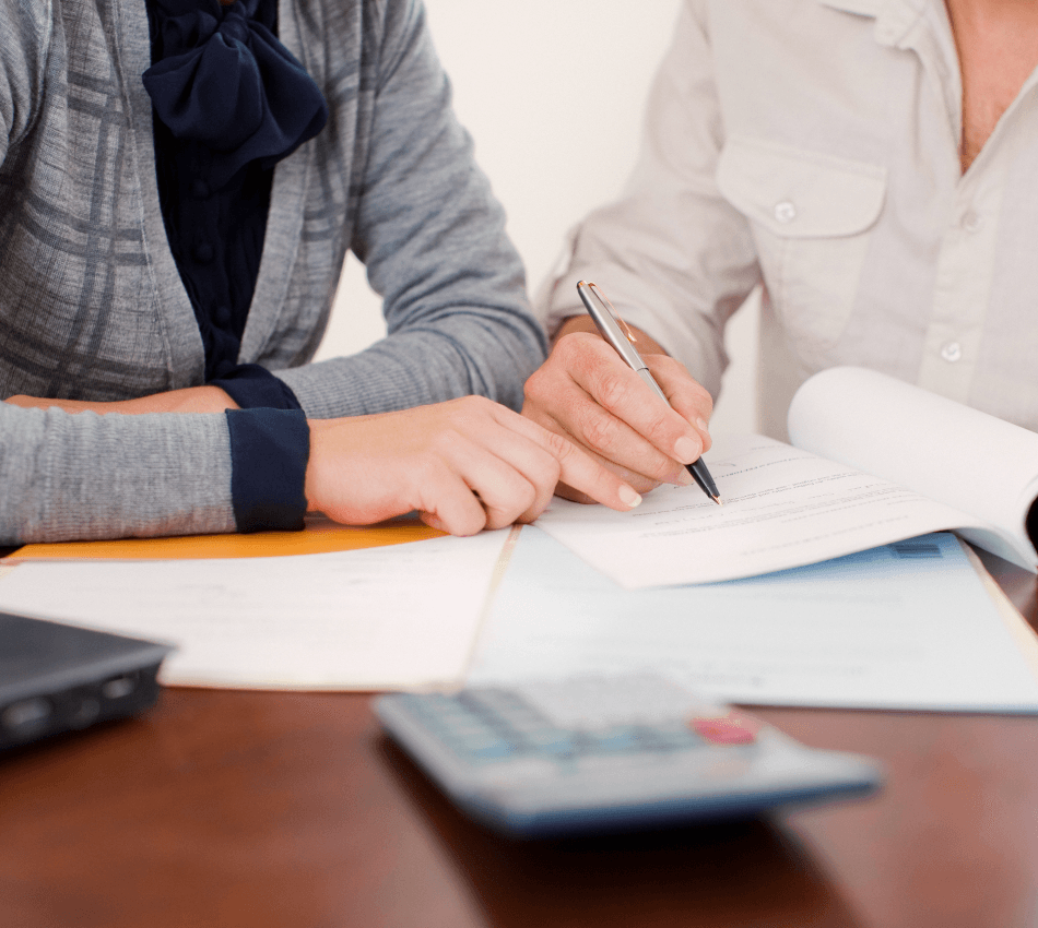 Close-up of an accountant helping a small business owner apply for a business loan.