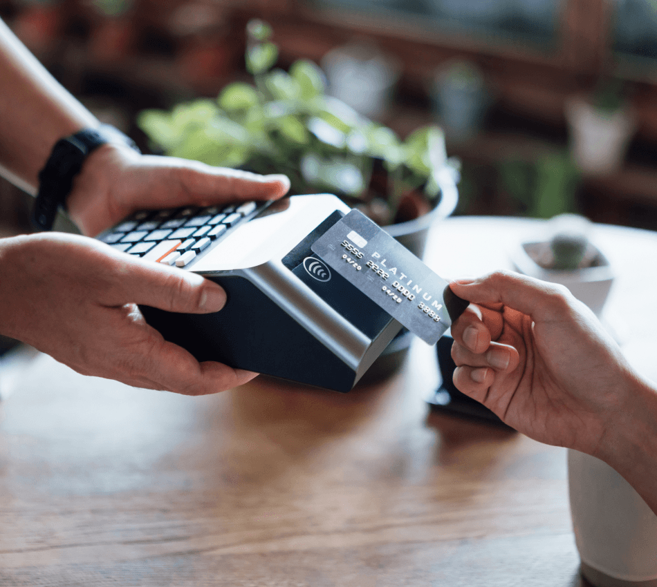 Close-up of a customer completing a contactless credit card transaction.