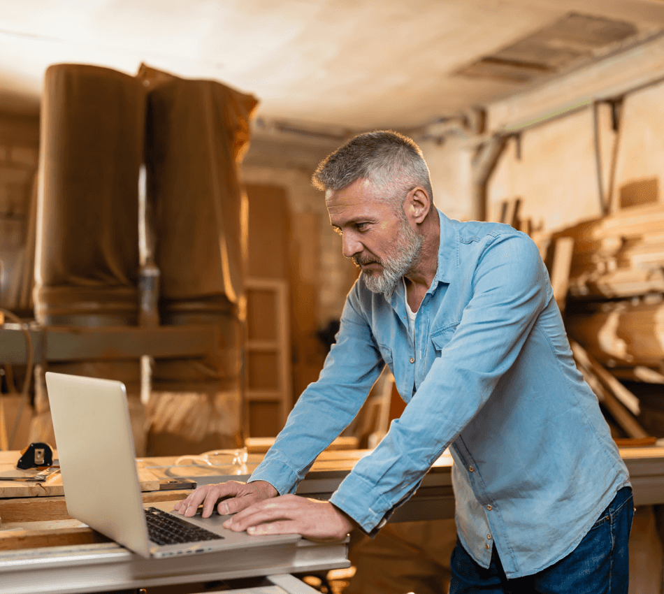 Construction company owner managing cash flow with online banking.