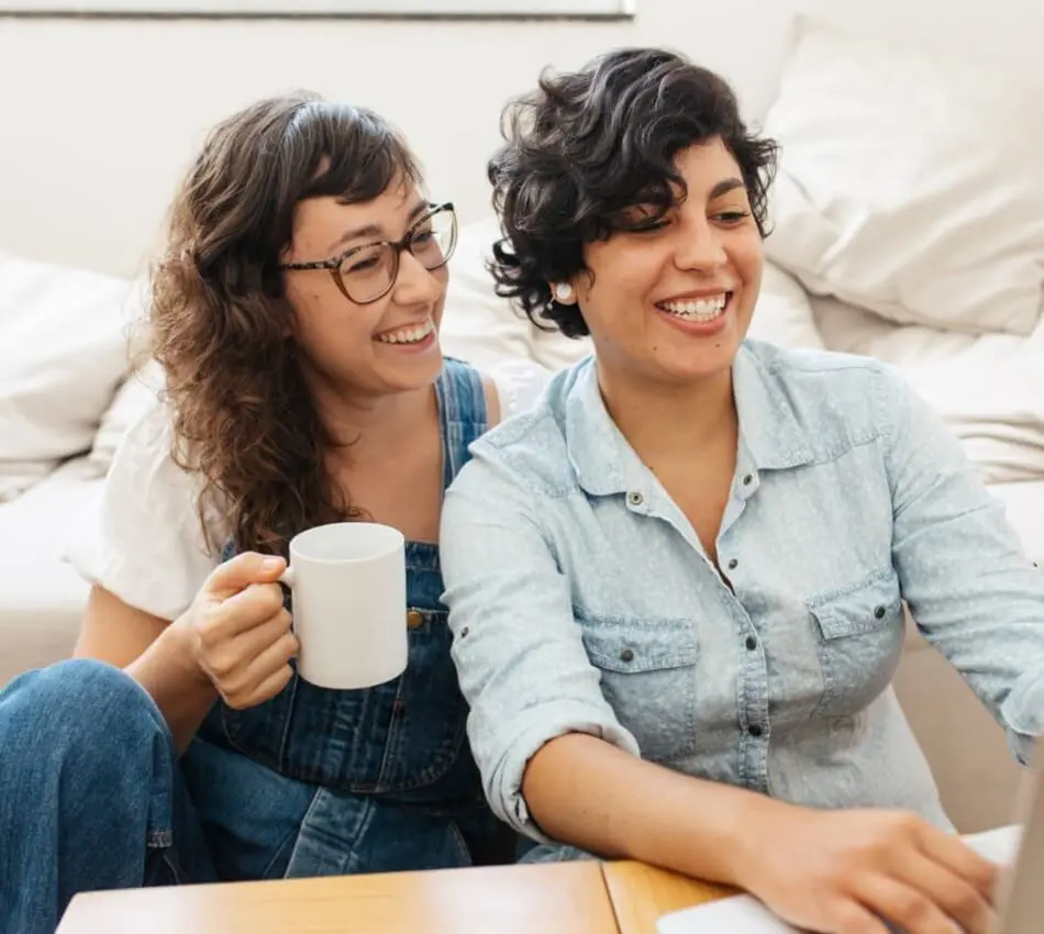 Young lesbian couple on their computer | LGBTQIA-owned business