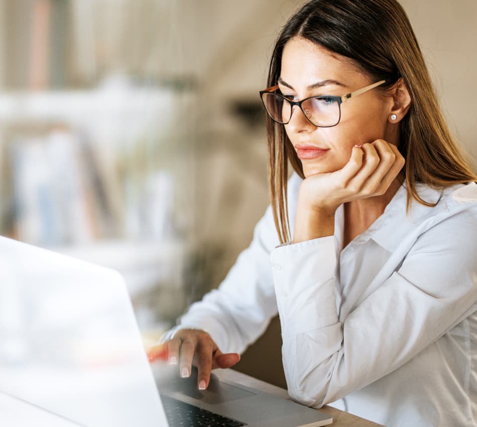Woman business owner works on laptop.