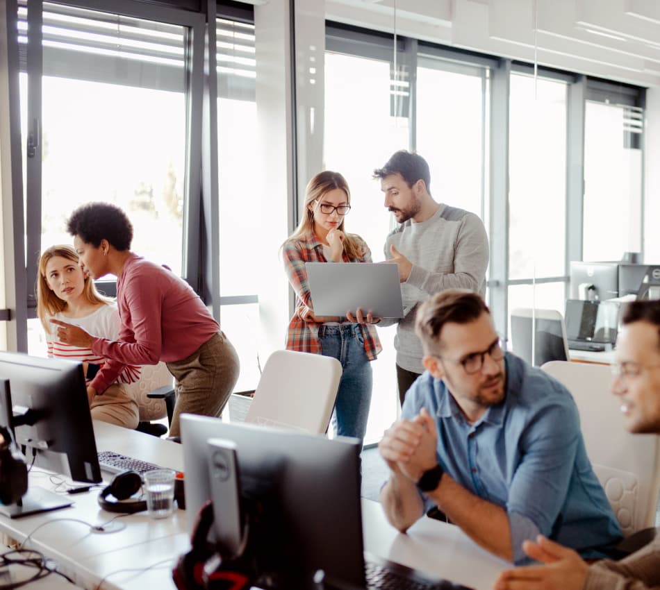 Small business team collaborates in open office environment.