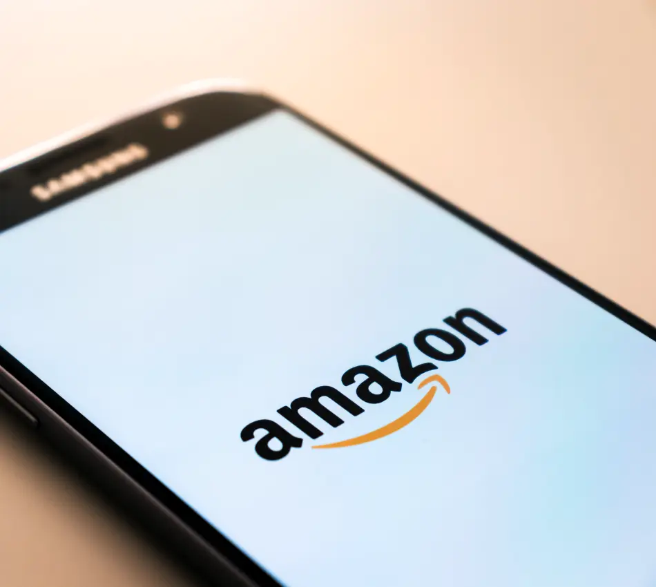 Close-up of a smartphone screen loading the Amazon app.