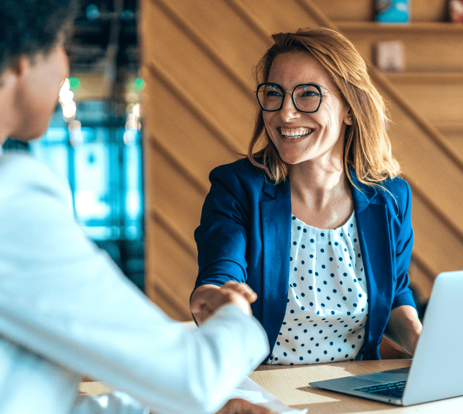 Salesperson shakes hands with client.