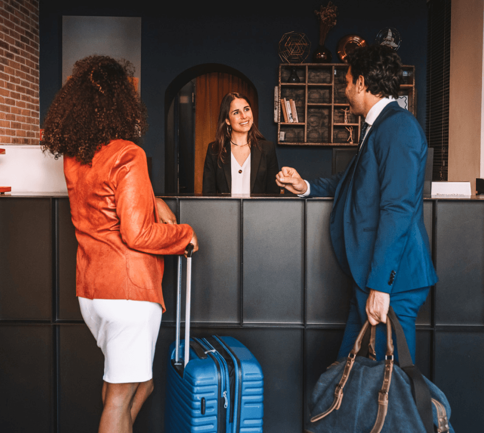 Guests check in at a hotel front desk.