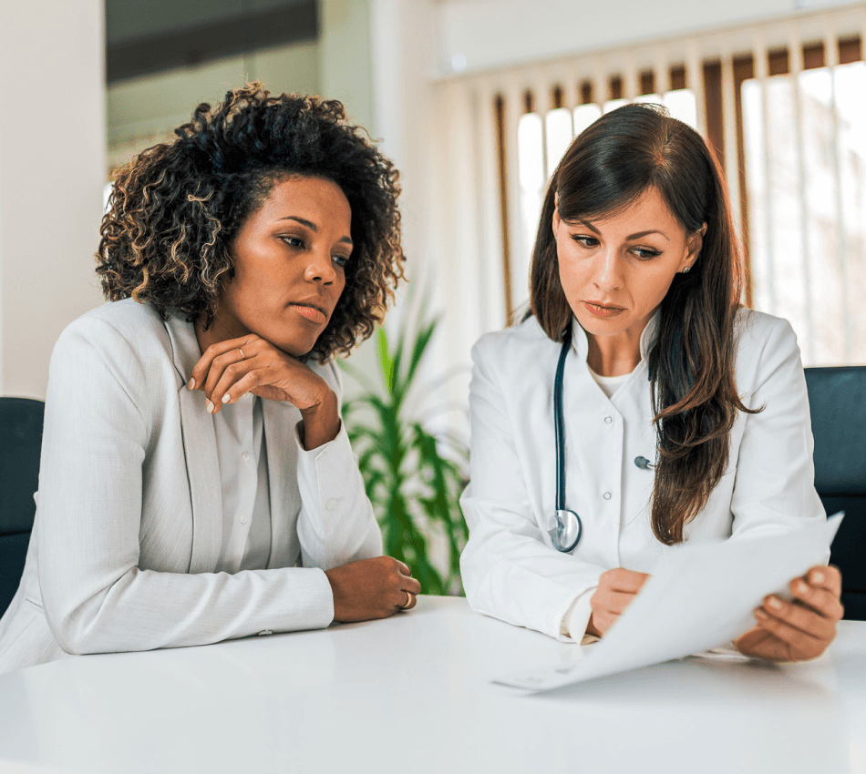 A doctor reviews documents with a patient.
