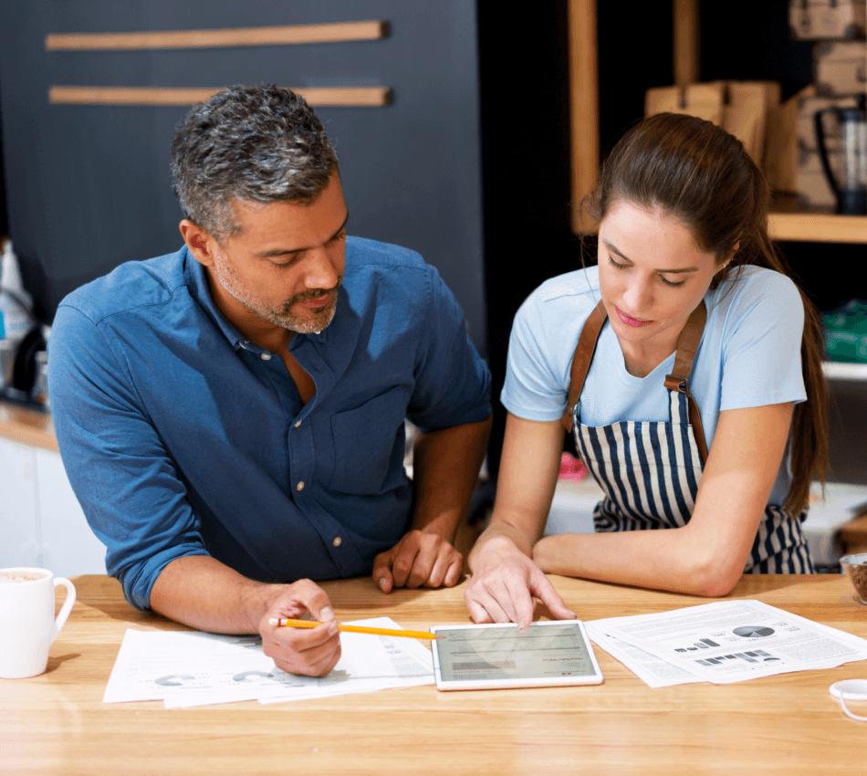 Coffee shop owners review finances as an example of good business credit management.