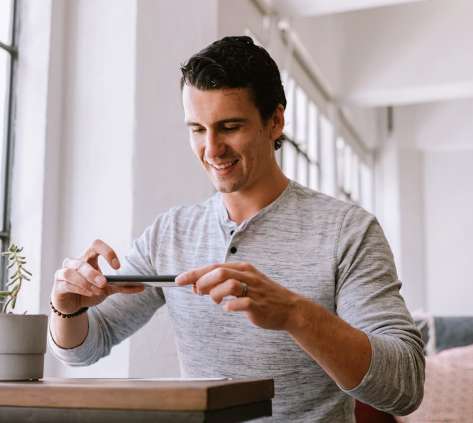 Small business owner uses mobile deposit to deposit a check from his phone.