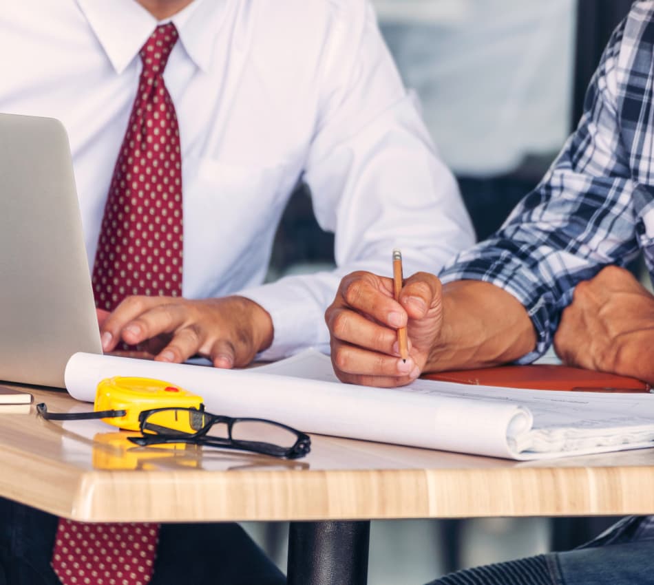 Close-up of a construction business owner signing a long-term project contract.